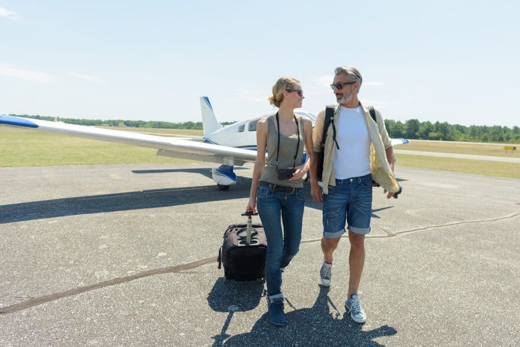 happy couple outside private jet